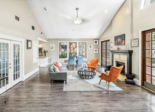 Leasing office lounge area with couch and a fireplace at Hunters Chase Apartments in Austin, TX