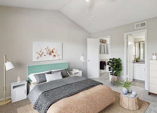 A bedroom with a large bed and a painting on the wall at Jefferson Creek Apartments in Irving, TX
