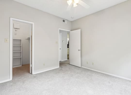 A1 floor plan bedroom with a ceiling fan at Jefferson Creek Apartments in Irving, TX.