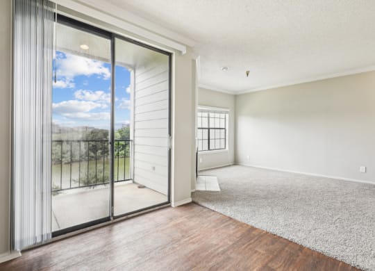 A2 floor plan dining and living room with sliding glass doors to a balcony at Jefferson Creek Apartments in Irving, TX.