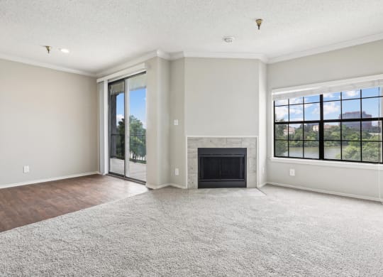A2 floor plan living room with a fireplace and sliding glass doors that open to balcony at Jefferson Creek Apartments in Irving, TX.