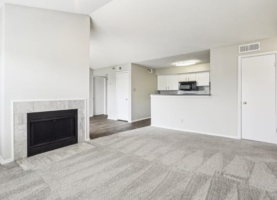 A3 floor plan living room with a fireplace and a kitchen at Jefferson Creek Apartments in Irving, TX.