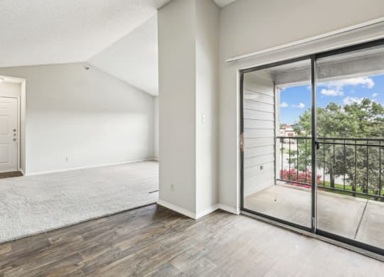 A3 floor plan living room with sliding glass doors to a balcony at Jefferson Creek Apartments in Irving, TX.