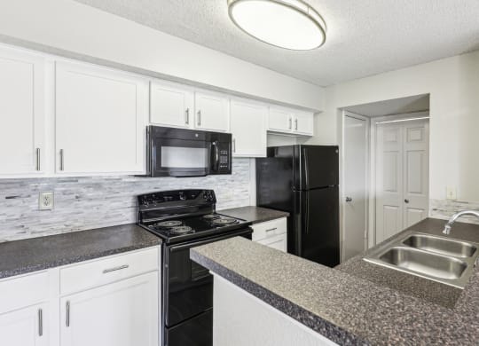 A3 floor plan kitchen with black appliances Jefferson Creek Apartments in Irving, TX.