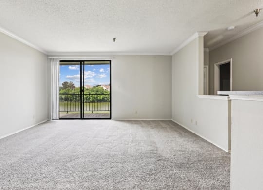 B1 living room with a sliding door to a balcony at Jefferson Creek Apartments in Irving, TX.