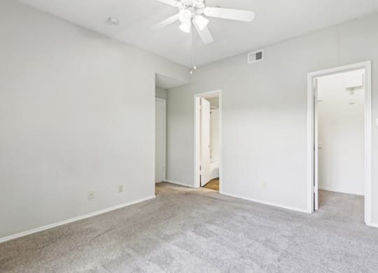 Second bedroom of B1 floor plan with walk-in closet and private bathroom at Jefferson Creek Apartments in Irving, TX.