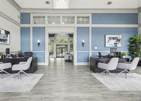 a lobby with blue walls and white furniture at Jefferson Creek in Irving, TX