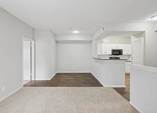 B2 living room with a kitchenette in the background at Jefferson Place Apartments in Irving, TX