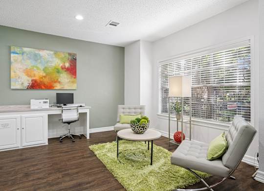 Business center with computer and seating with a coffee table at La Costa in Plano, TX