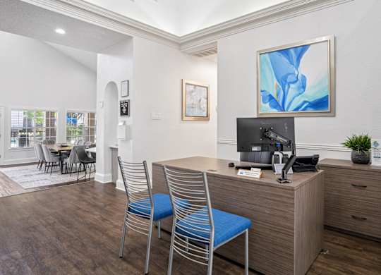 Leasing office with staff desk and two blue chairs at La Costa in Plano, TX