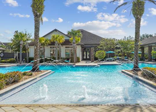A pool with a fountain in the middle of it.
