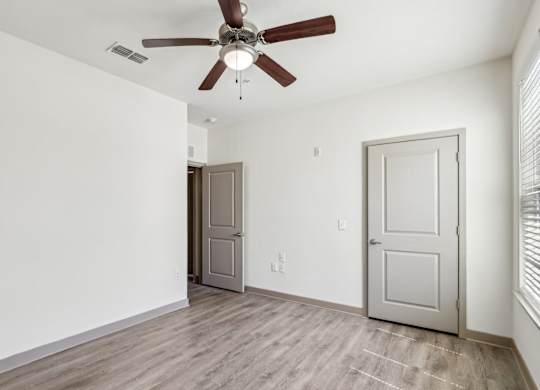 Royal Palm bedroom with a ceiling fan at Oakleaf Plantation apartments in Jacksonville, FL.