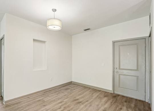 Royal Palm entryway with a wooden floor and white walls at Oakleaf Plantation Apartments in Jacksonville, FL
