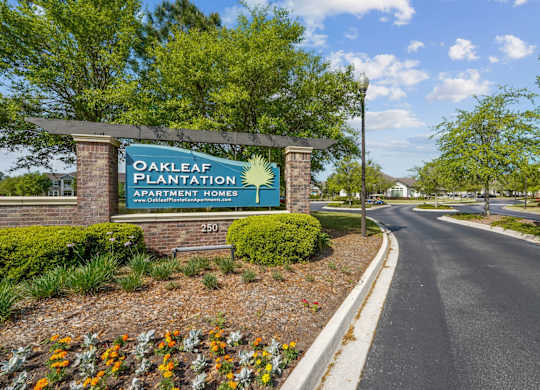 Property sign for Oakleaf Plantation Apartment Homes at the community entrance in Jacksonville, FL