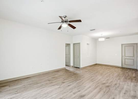 A room with a ceiling fan and wooden flooring at Oakleaf Plantation Apartments in Jacksonville, FL