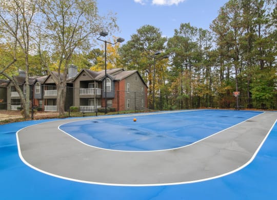 a basketball court with apartments in the background at Woodmere Trace at Duluth, GA
