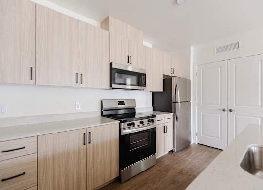 A kitchen with wooden cabinets and stainless steel appliances.