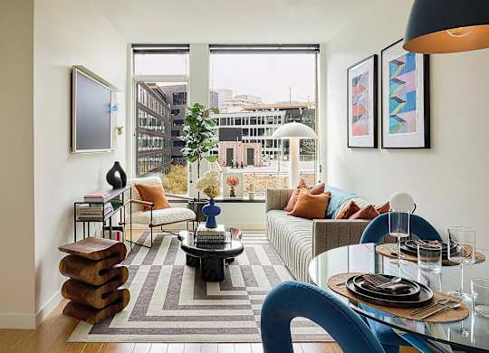 A modern living room with a large window overlooking the city.