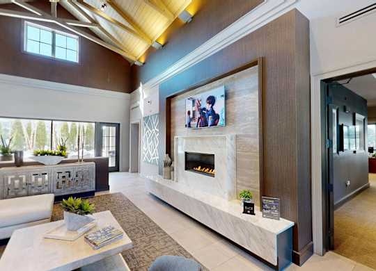 A modern living room with a fireplace and a flat screen TV mounted on the wall.