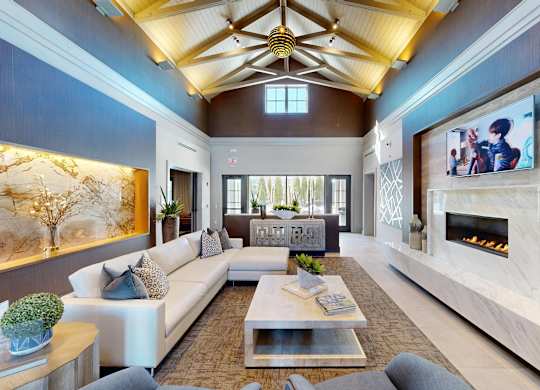 A modern living room with a fireplace and a television.