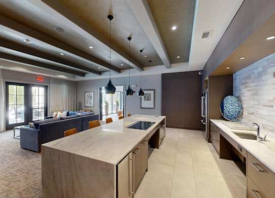 A modern kitchen with a large island and a dining area.