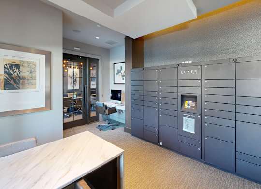 A modern office space with a wooden table and chairs, and a wall of lockers.