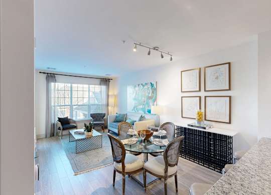 A dining room with a glass table and chairs.