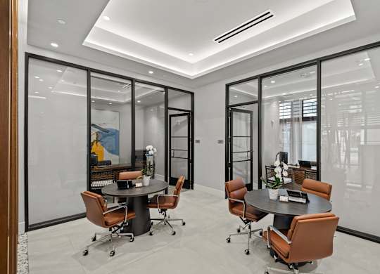 A conference room with a table and chairs.