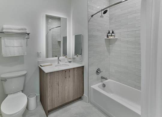 A white bathroom with a toilet, sink, and bathtub.