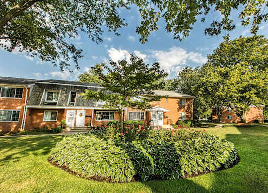 A building with a green lawn in front of it.