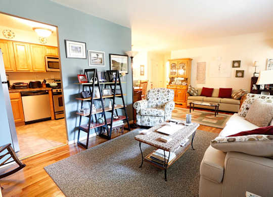 A living room with a couch, chair, and coffee table.