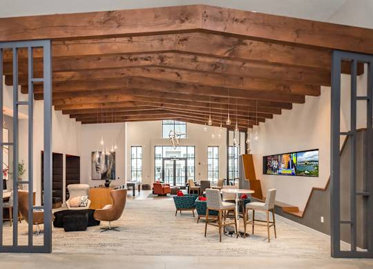 A modern interior with a wooden ceiling and a staircase.