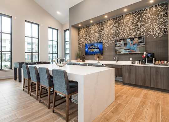 A modern kitchen with a white countertop and wooden flooring.