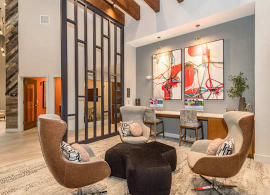 A modern living room with a large abstract painting on the wall.