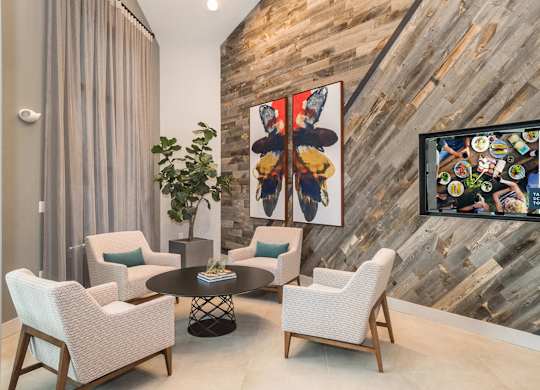 A living room with a wooden wall and a painting on it.