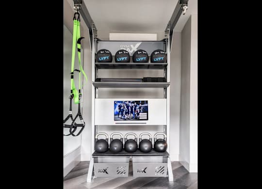 A gym setup with kettlebells and weight lifting equipment.