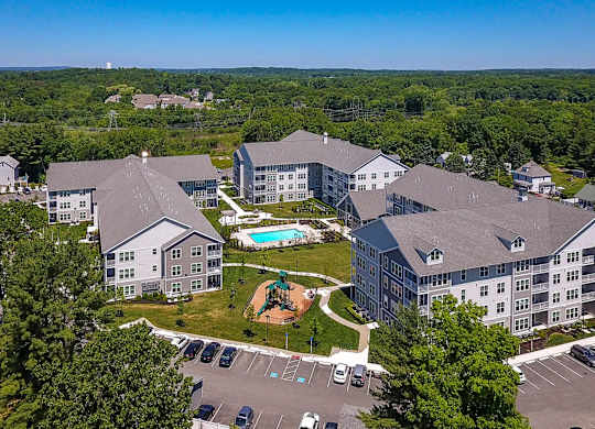 A large building complex with a pool and playground.