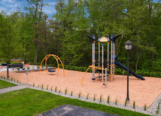 A playground with a slide, swings, and a climbing frame.