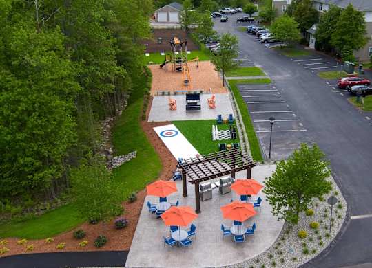 A park with a playground and picnic tables.