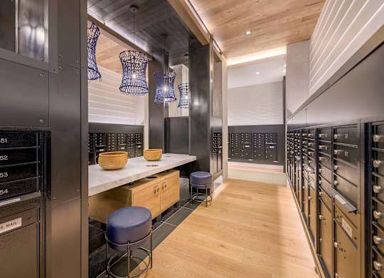 A modern kitchen with wood floors and stainless steel appliances.