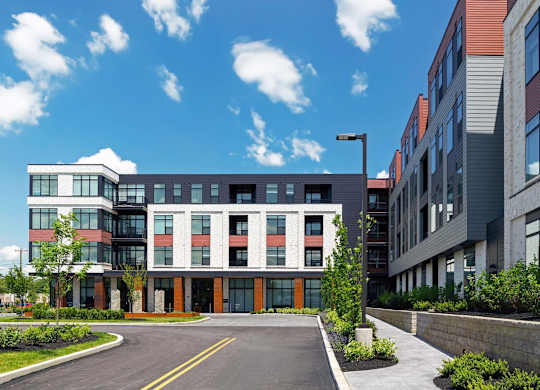 A modern building with a red and white entrance.