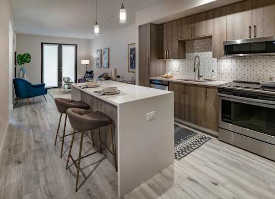A modern kitchen with a bar area and a dining area.