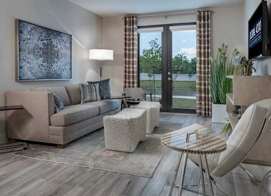 A living room with a couch, chair, and television.