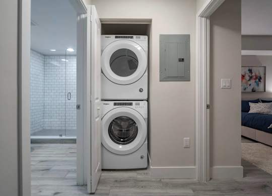 A white front loading washing machine is in a doorway.