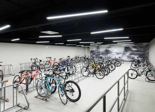 A bike rack full of bicycles in a bike room.