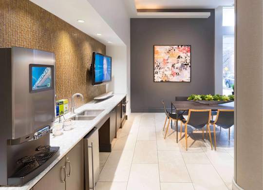 A modern kitchen with a dining table and chairs.