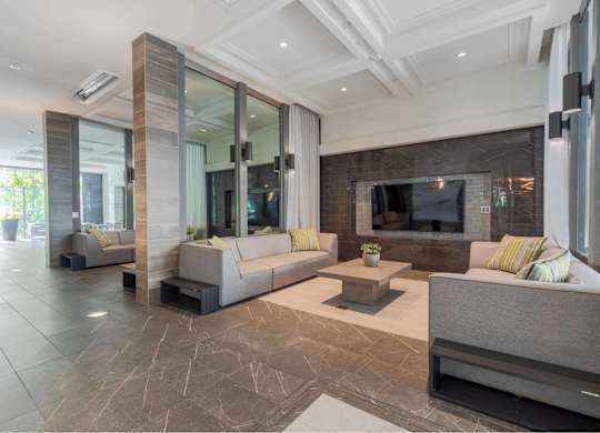 A modern living room with a grey sofa and a coffee table.