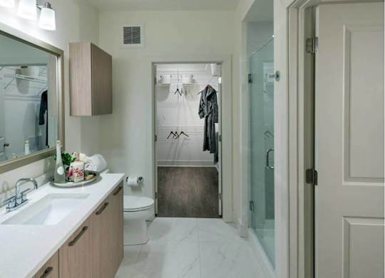 A bathroom with a white sink and a mirror.