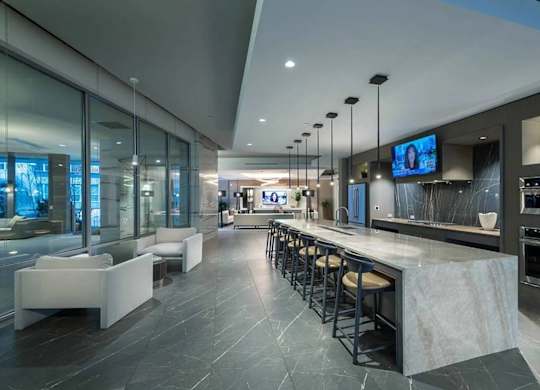 A modern kitchen with a bar area and seating.