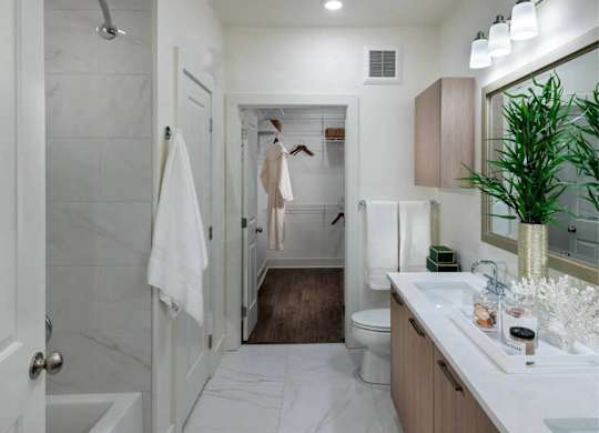 A bathroom with a white tub and a white sink.